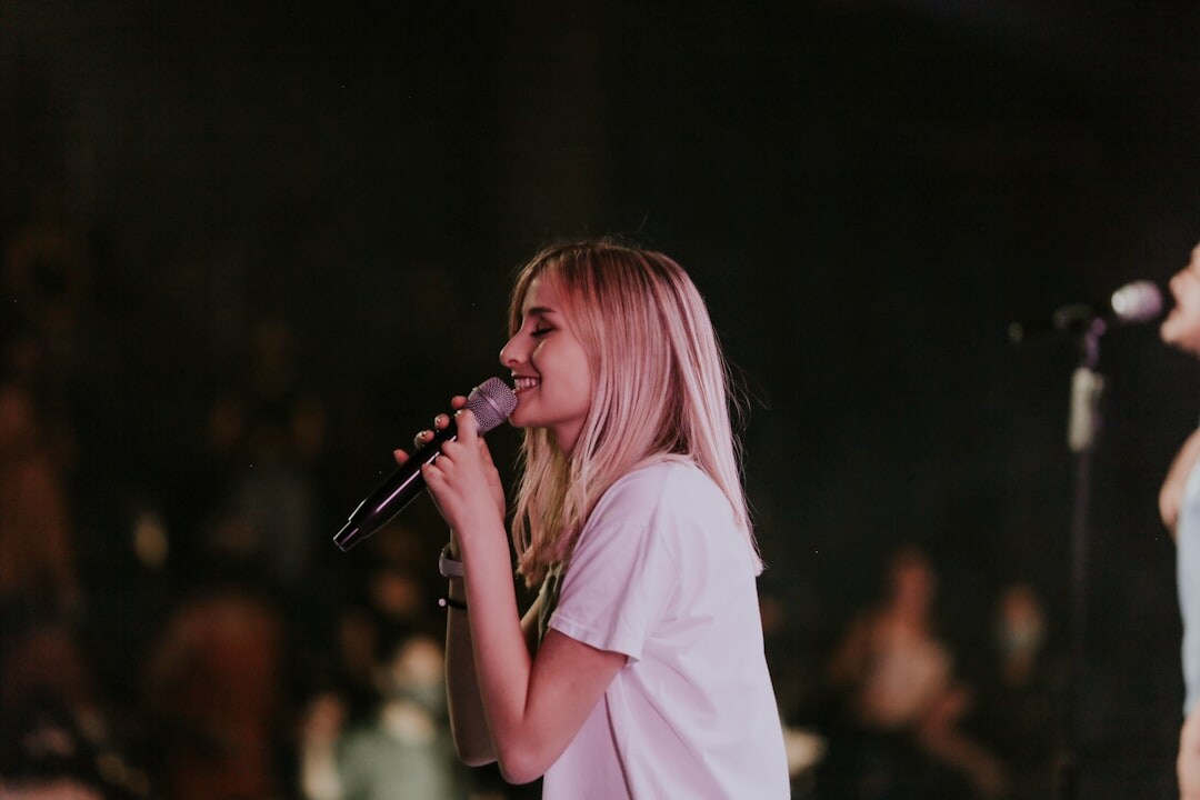 woman singing on stage
